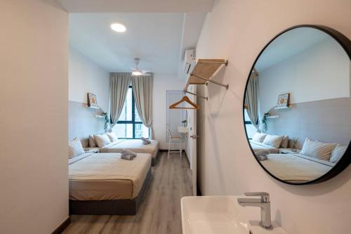 a bathroom with two beds and a mirror at Cubic Botanical Chill Massage Chair 7km- MidValley in Kuala Lumpur