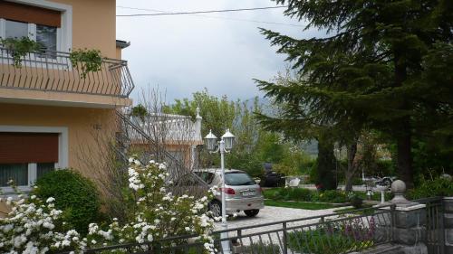 a car parked in a parking lot next to a building at AUTOMOTODROM GROBNIK - Apartments and Rooms Skejić in Čavle