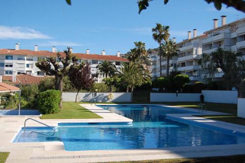 a swimming pool in front of a apartment building at Balmins White by Hello Homes Sitges in Sitges