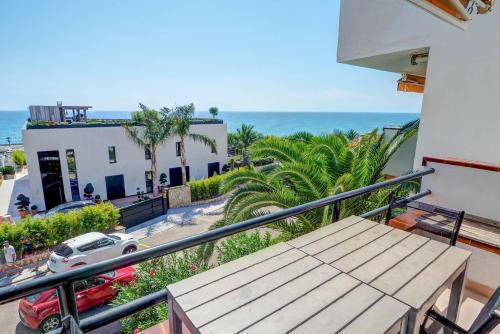 a balcony with a table and a view of the ocean at Balmins White by Hello Homes Sitges in Sitges