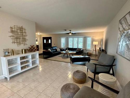 a large living room with a couch and chairs at Villa Palaco in Cape Coral