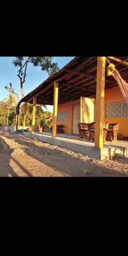 a building with a pavilion with a tree in the background at CASA CERCA DEL MAR ZIHUATANEJO in El Coacoyul