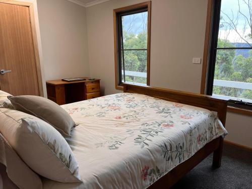 a bedroom with a bed and a window at Mountain Tranquility in Mount Tomah