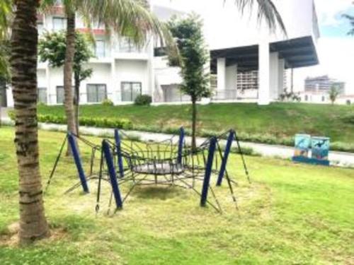 a batting cage in a yard next to a palm tree at THE CAM RANH RESORT at Bai Dai in Cam Ranh