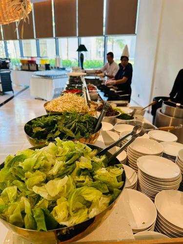 a buffet line with plates and bowls of food at THE CAM RANH RESORT at Bai Dai in Cam Ranh