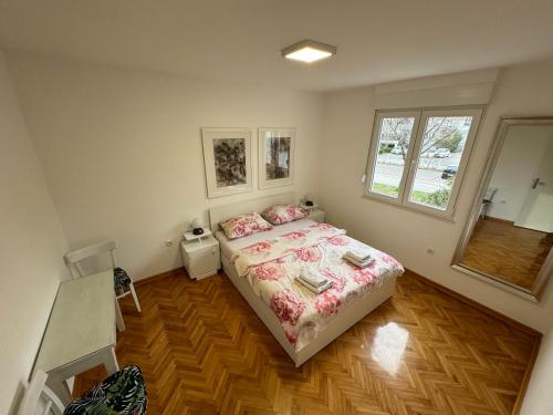 a small bedroom with a bed and a window at Apartman PARK in Trebinje