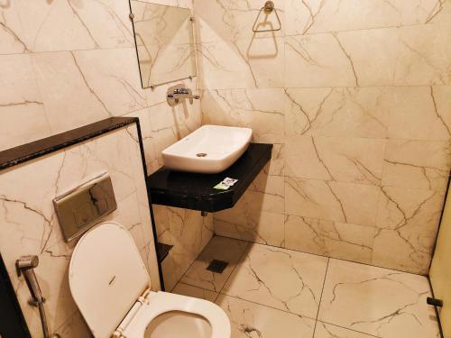 ein Bad mit einem WC und einem Waschbecken in der Unterkunft Hotel Krone A Family Hotel Near IGI Airport in Neu-Delhi