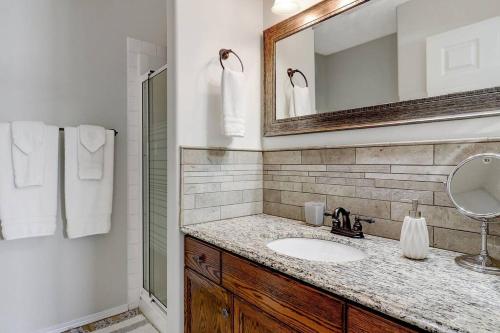 a bathroom with a sink and a mirror at Bright and Spacious Home away from home in Grande Prairie