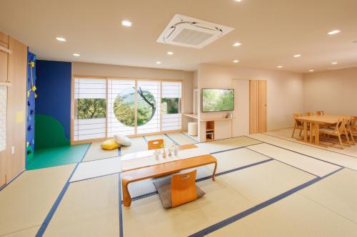 a living room with a table and a dining room at Arima Onsen Motoyu Ryuusenkaku in Kobe
