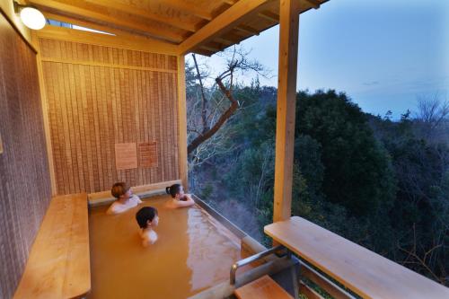 two children playing in the water in a house at Arima Onsen Motoyu Ryuusenkaku in Kobe