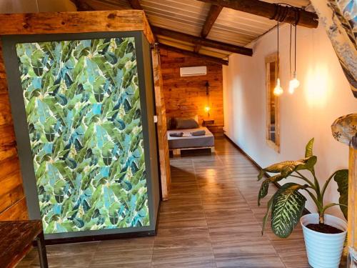 a large glass door in a room with a couch at Bon Vivant Front de Mer - Ile Rodrigues in Rodrigues Island