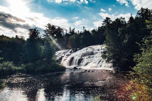 a waterfall in the middle of a river at Snow Otter Haus in Bessemer