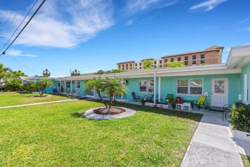 a house with a lawn in front of it at Captain's Quarters - Weekly Rental apts in Clearwater Beach