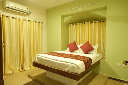a bedroom with a large bed with red pillows at 2 BHK beach goan villa with pool calangute in Calangute