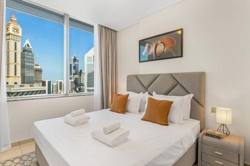 a bedroom with a large bed with a large window at DIFC 1BR at SkyGardens Tower in Dubai