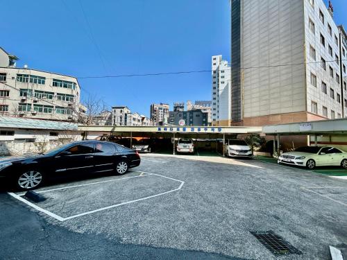 a car parked in a parking lot in a city at Prada motel in Geoje 
