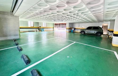 a parking garage with a car parked in it at Prada motel in Geoje 