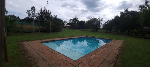 a swimming pool in the middle of a yard at HOLLYBROOKE Campsites in Skeerpoort