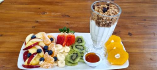 a white plate of food with a blender and fruit at HOLLYBROOKE Campsites in Skeerpoort
