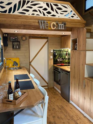 a kitchen with a table and chairs in a kitchen at La Tiny House de Nanou in Rochefort