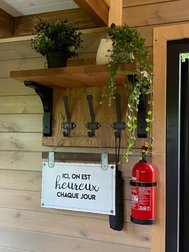 a sign on the side of a house with a fire hydrant at La Tiny House de Nanou in Rochefort