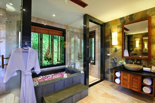 a bathroom with a bath tub and a sink at Seaview Villa at Surin Beach in Thalang