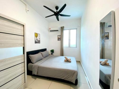 a bedroom with a bed and a ceiling fan at JOVIAL Modern Cozy Suite `Metropol BM BandarPerda in Bukit Mertajam