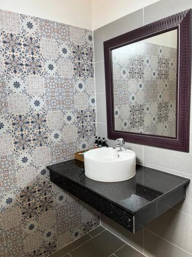 a bathroom with a sink and a mirror at Ninila Villa Phu Quoc in Phu Quoc