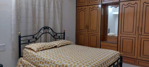 a bedroom with a bed and a dresser and a mirror at Suburbs Holiday Home in Dabolim