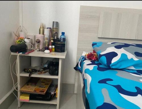 a bedroom with a bed and a nightstand next to a bed sidx sidx sidx at A 7 Villa in Quartier Militaire