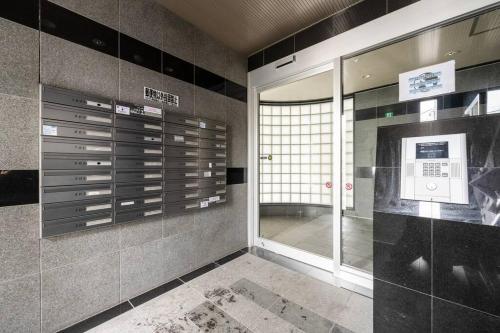a room with a wall of lockers in a building at Shizuk +O Stay 2 in Kita-sanjō