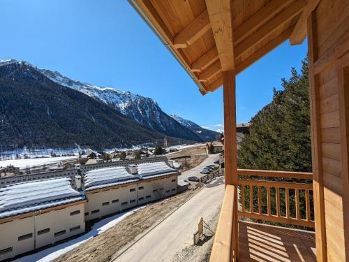a view from the balcony of a cabin with snow covered mountains at chalet panoramique in Ceillac