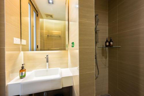 a bathroom with a sink and a shower at Greystone 99 Suites in Melaka