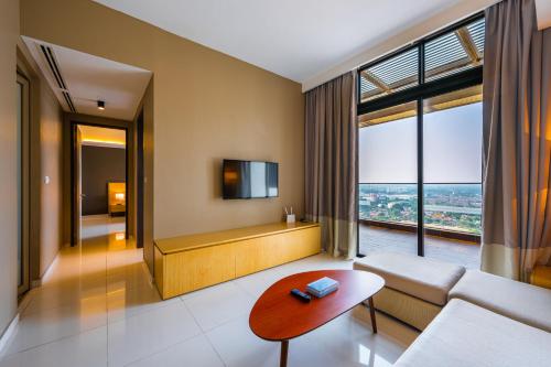 a living room with a couch and a table at Greystone 99 Suites in Melaka