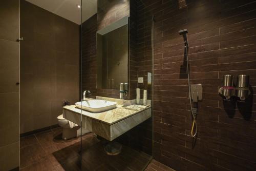 a bathroom with a sink and a toilet and a shower at 1825 Gallery Hotel in Melaka