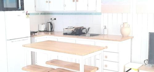 a kitchen with white cabinets and a counter top at Entire Guest Suite - beach is 1 and half km - Pets Welcome in Gold Coast