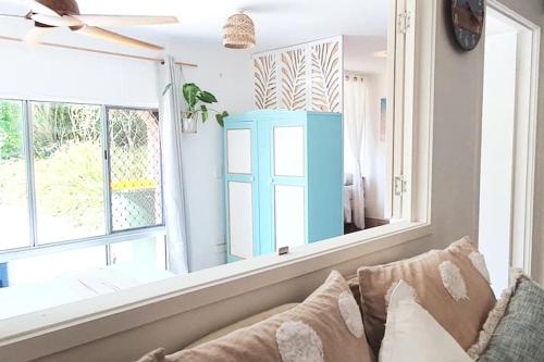 a living room with a couch and a large mirror at Entire Guest Suite - beach is 1 and half km - Pets Welcome in Gold Coast