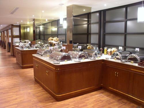 a hair salon with a row of sinks and mirrors at Swiss International Al Hamra Hotel in Dammam