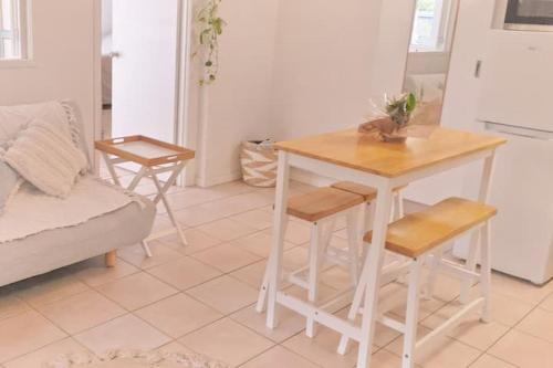 a kitchen with a table and chairs and a couch at Entire Guest Suite - Close to Beach - Pets Welcome in Gold Coast