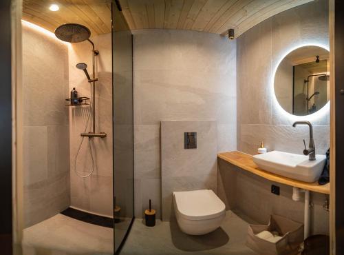 a bathroom with a shower and a toilet and a sink at Kimmelvilla - Wilderness in your living room in Pyhätunturi