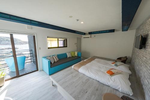 a bedroom with a bed and a couch at XYZ Private Spa and Seaside Resort in Shirahama