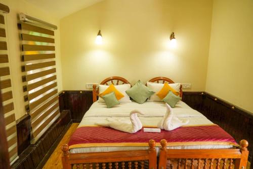 a bedroom with a bed with towels on it at St. Mary Houseboat in Kumarakom