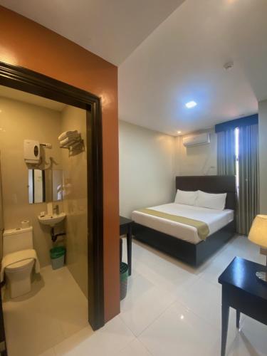 a hotel room with a bed and a bathroom at Eight Breeze in Baclayon