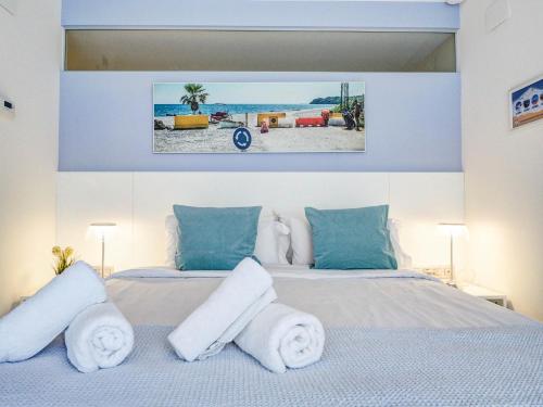 a bedroom with a bed with towels on it at Blue Serenity by Hello Homes Sitges in Sitges