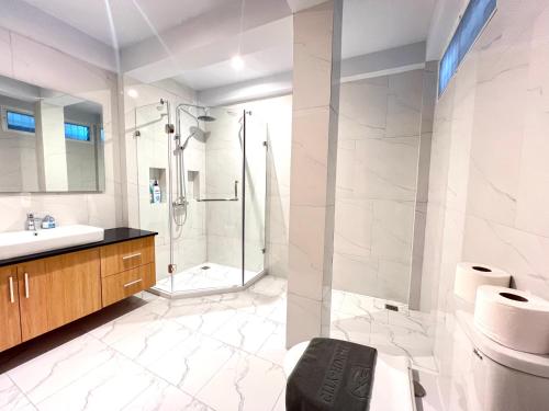 a bathroom with a shower and a sink at City house- 171, Private pool villa 4 bed5bath near walking St, BBQ in Pattaya South