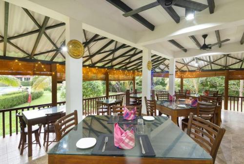 a restaurant with tables and chairs in a room at The Hideout Sigiriya in Sigiriya