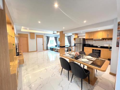 a kitchen with a table and chairs in a room at City house- 171, Private pool villa 4 bed5bath near walking St, BBQ in Pattaya South