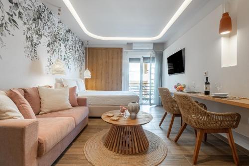 a living room with a couch and a table at Loutraki Flamingo Feather in Loutraki