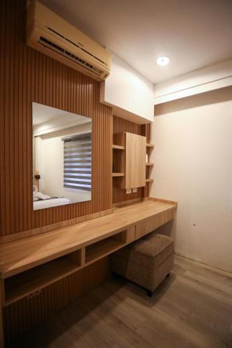 a bathroom with a large mirror and a wooden wall at Forest Crest Nature Hotel and Resort Powered by ASTON in Nasugbu