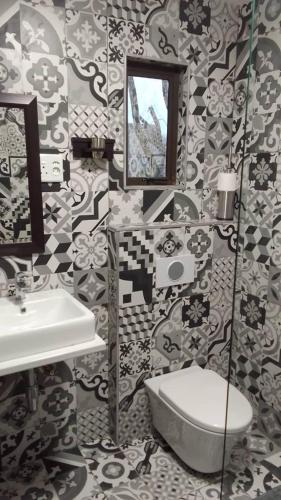 a bathroom with a sink and a toilet at Kangumine Self Catering Units in Okakarara